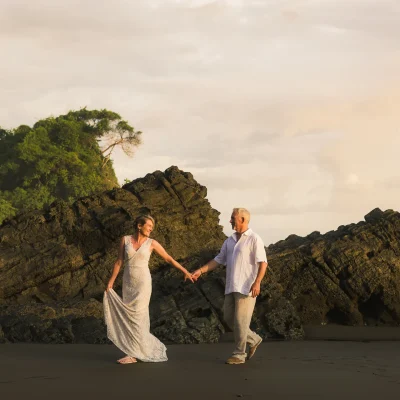 Couple walking hand in hand during a sunset beach photoshoot in Uvita, Costa Rica